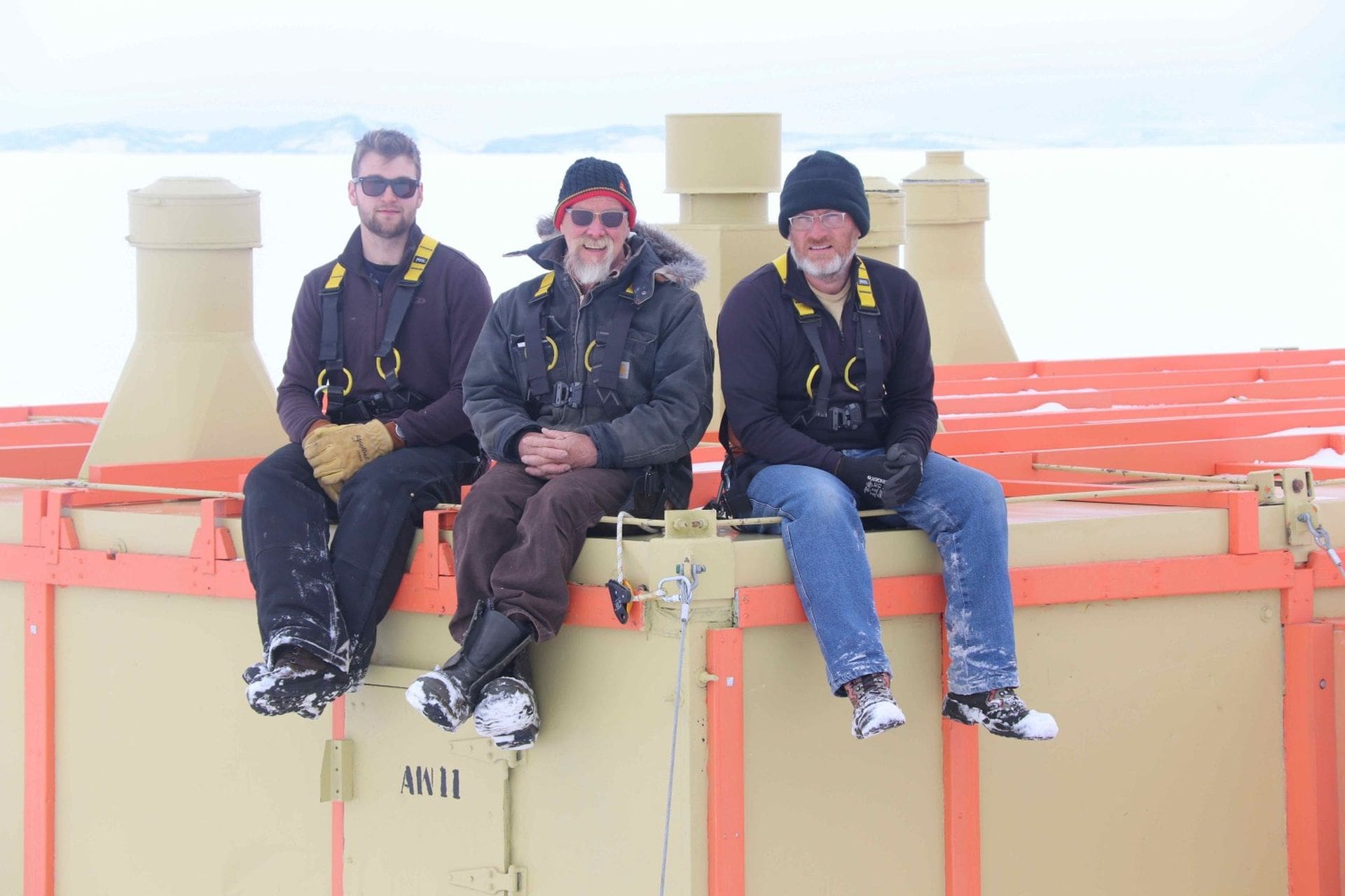 Chris Ansin, Al Fastier and Geoff Cooper taking a break on the roof of the hut.