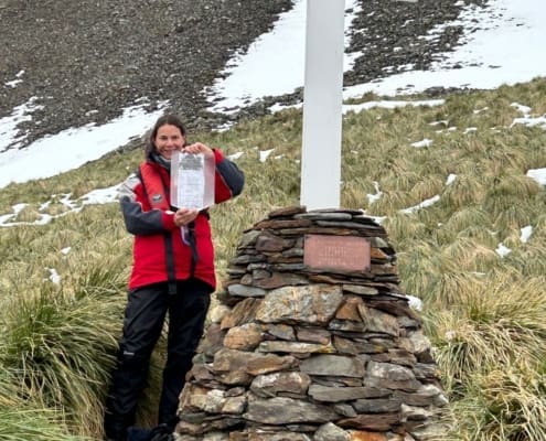 Rachel Carr at the Hope Point memorial cross. Grytviken Antarctic Heritage Trust Inspiring Explorers Expedition